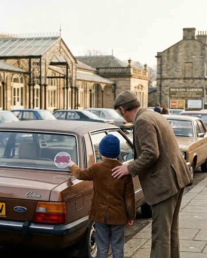 Recreated photo: a young boy in a blue bobble hat and his dad in a flat cap, seen from behind in Buxton by the Pavilion Gardens, the boy pointing at a round Piccadilly Radio 261 sticker in the back window of a brown 1970s Ford Cortina.