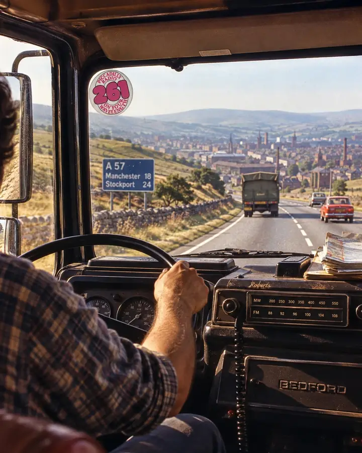 Recreated photo: the view from a Bedford lorry cab coming down off the Pennines towards Greater Manchester, the driver's hand on the wheel, a Piccadilly Radio 261 sticker on the windscreen and a Roberts radio in the dashboard.